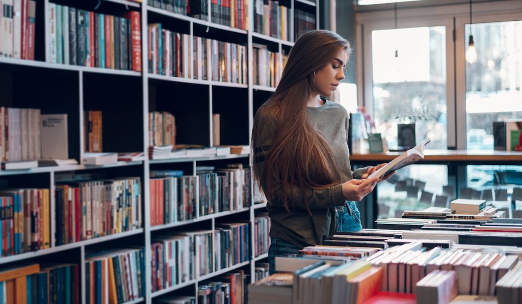 woman buying a new book to read